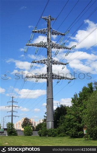 Power line over the white clouds and blue sky