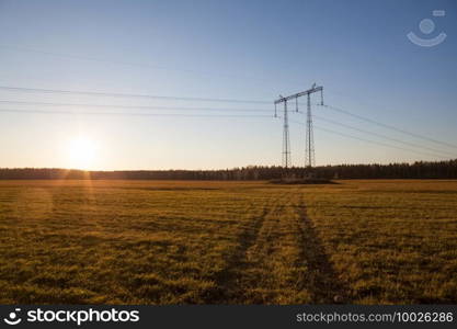 Power line supports. Electricity transmission and posts.. Power line supports. Electricity transmission