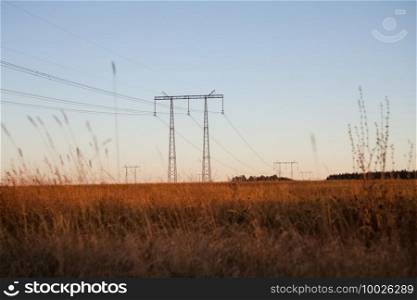Power line supports. Electricity transmission and posts.. Power line supports. Electricity transmission