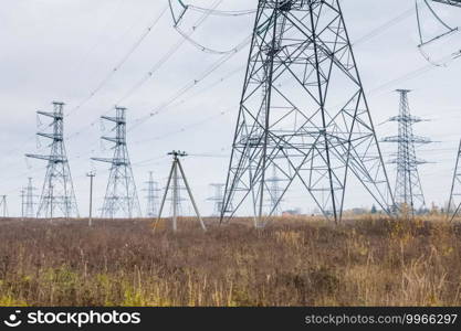 Power line supports. Electricity transmission and posts.. Power line supports. Electricity transmission