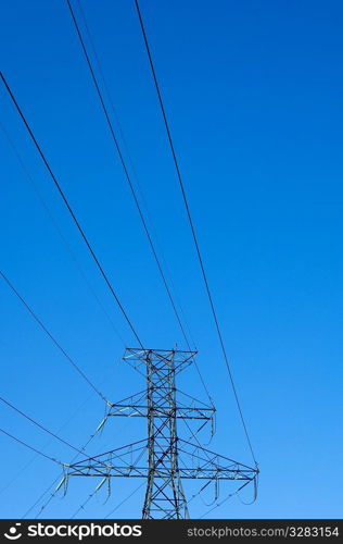 Power lines against blue sky.