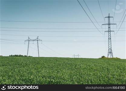 Power lines in countryside, on field outside the city.