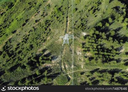 Power lines in the forest. Electric tower line in forest Landscape. Ariel view High voltage power pylons .. Power lines in the forest. Electric tower line in forest Landscape. Ariel view High voltage power pylons.