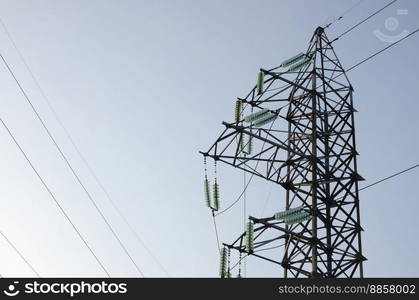 Power lines tower against the blue sky