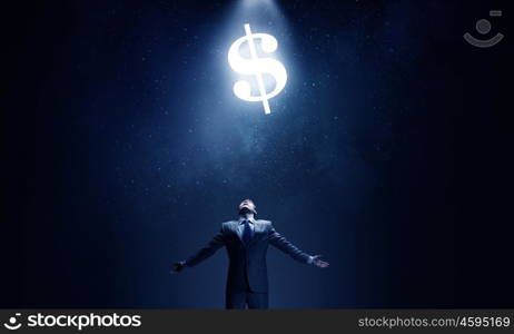Power of money. Businessman with hands spread apart and dollar sign above