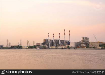 Power plant during the evening Power stations that are located along the river during the Twilight