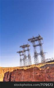 Power plant house and power line over Electricity generating dam in Page Arizona USA