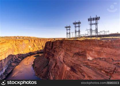Power plant house and power line over Electricity generating dam with river colorado in Page Arizona USA