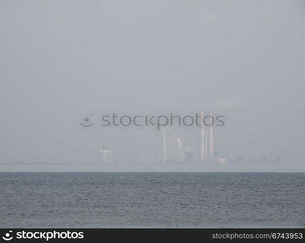 power plant in fog. Avedoere Power Station south of copenhagen. one of the most efficient power stations in the world.