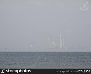 power plant in fog. Avedoere Power Station south of copenhagen. one of the most efficient power stations in the world.