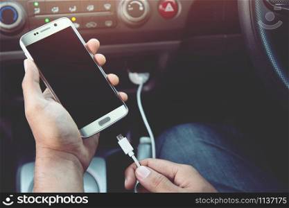 Power plug charging phone in car.