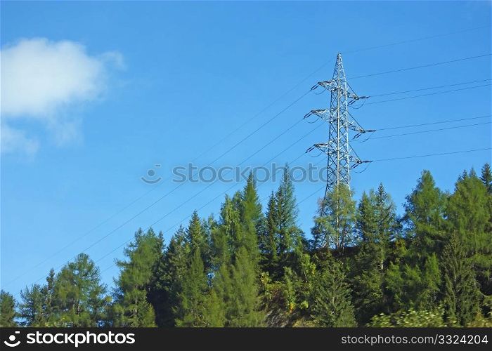 Power pylon in a wood, in front of sky