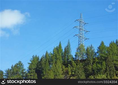 Power pylon in a wood, in front of sky