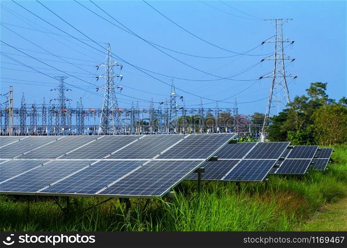 power solar panel and High voltage post in Power plant on blue sky background,alternative clean green energy concept