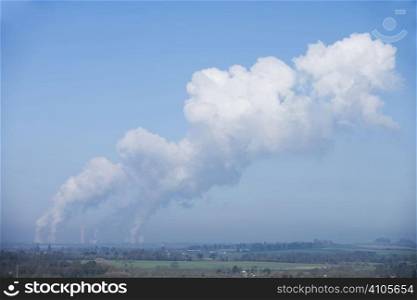 power station bellowing emitting smoke from chimneys