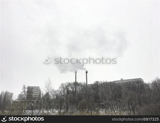 Power station in city. Industrial urban warm tower winter landscape. Power station in city.