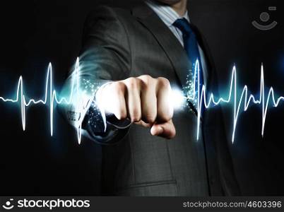Powerful businessman. Close up of businessman grasping cardiograph in fist