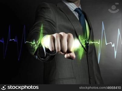 Powerful businessman. Close up of businessman grasping cardiograph in fist