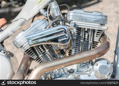 powerful chromed motorcycle engine and exhaust pipe closeup