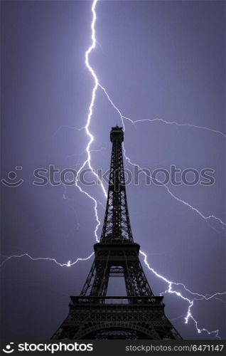 Powerful lightning strike. Eiffel tower , Paris, France. Powerful lightning strike.