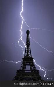 Powerful lightning strike. Eiffel tower , Paris, France. Powerful lightning strike.
