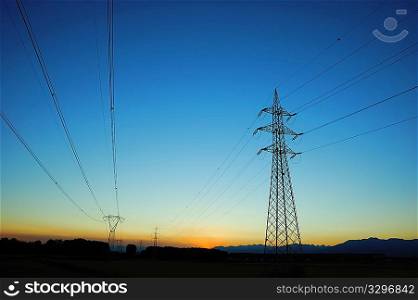 Powerlines extend to the horizon at dusk