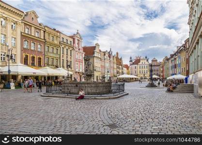 POZNAN, POLAND - AUGUST 04, 2014: An old shopping area with historical perimeter houses, a plague column and a fountain in the city of Poznan. Poland