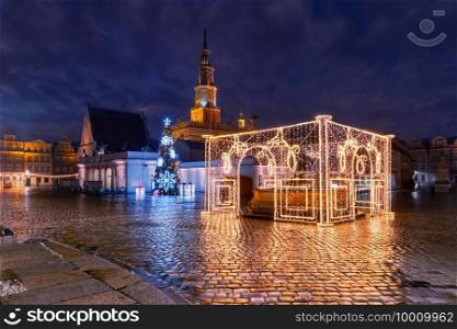 Poznan Town Hall and decorated fountain on Old Market Square in Old Town in the Christmas night, Poznan, Poland. Night Old Town of Poznan, Poland