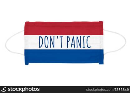 PP non-woven disposable medical face mask isolated on white background. Don&rsquo;t panic lettering on medical mask toned in Netherlands flag colors. PP non-woven disposable medical face mask isolated on white background