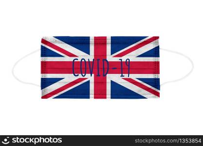 PP non-woven disposable medical face mask isolated on white background. Covid lettering on medical mask toned in United Kingdom flag colors. PP non-woven disposable medical face mask isolated on white background