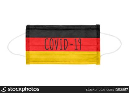 PP non-woven disposable medical face mask isolated on white background. Covid lettering on medical mask toned in Germany flag colors. PP non-woven disposable medical face mask isolated on white background