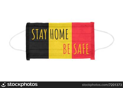 PP non-woven disposable medical face mask isolated on white background. Stay home and be safe lettering on medical mask toned in Belgium flag colors. Stay home and be safe lettering on medical mask toned in Belgium flag colors