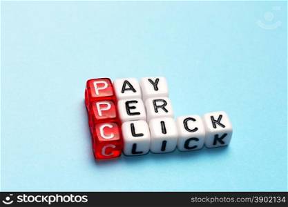 PPC Pay Per Click text on dices on blue background