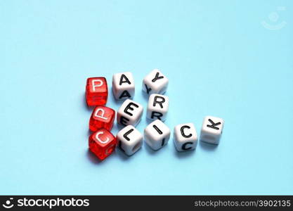 PPC Pay Per Click text on dices on blue background