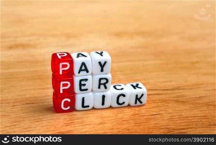 PPC Pay Per Click text on dices on wooden background