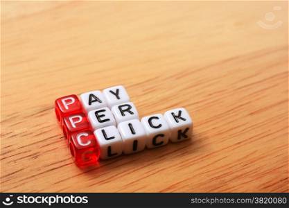 PPC text , pay per click cubes on wooden background