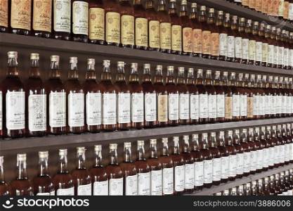 Prachuap Khiri Khan - NOVEMBER 16: Thai whiskey bottle arranged on shelf wall as background on November 16, 2014 in Prachuap Khiri Khan, Thailand