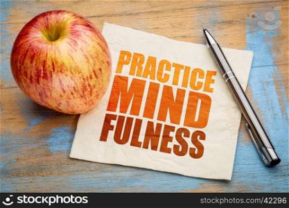 Practice mindfulness - motto or resolution on a napkin with an apple