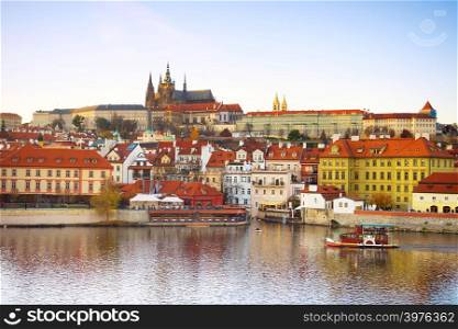 Prague Castle, Vltava river and old touristic boat. Czech Republic