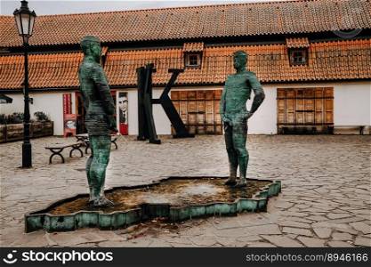 Prague, Czech - February 2023. Statue of peeing figures men by David Cerny. High quality photo. Prague, Czech - February 2023. Statue of peeing figures men by David Cerny.