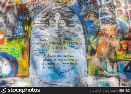 PRAGUE, CZECH REPUBLIC - APRIL 29, 2016: John Lennon Wall has been filled with Lennon inspired graffiti and lyrics from Beatles’ songs since the 1980s as irritation of the communist regime.. John Lennon Wall, Prague, Czech Republic. Graffiti background