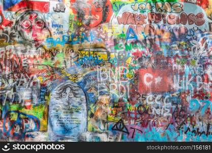 PRAGUE, CZECH REPUBLIC - APRIL 29, 2016: John Lennon Wall has been filled with Lennon inspired graffiti and lyrics from Beatles? songs since the 1980s as irritation of the communist regime.. John Lennon Wall, Prague, Czech Republic. Graffiti background