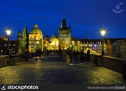 PRAGUE - MARCH 06: Charles bridge in the evening on March 06, 2017 in Prague. This famous historic bridge crosses the Vltava river and was constructed in the beginning of the 15th century.