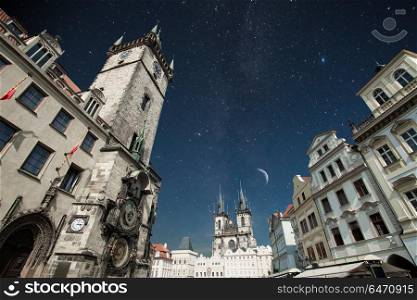 Prague Old town square, Tyn Cathedral. under sunlight. At night the stars shine and the moon.. Prague under sunlight.