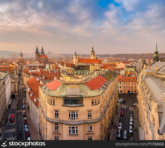 Prague red roofs and spires of historical Old Town of Prague. Cityscape of Prague on a sunset frosty. Red rooftops, spires and Prague castle in the background. Prague, Czechia. Space for text