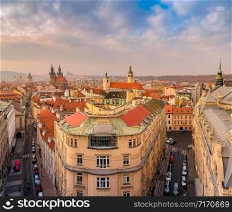 Prague red roofs and spires of historical Old Town of Prague. Cityscape of Prague on a sunset frosty. Red rooftops, spires and Prague castle in the background. Prague, Czechia. Space for text