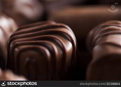 Praline Chocolate on wooden backgroud. Chocolate bars and pralines on wooden background