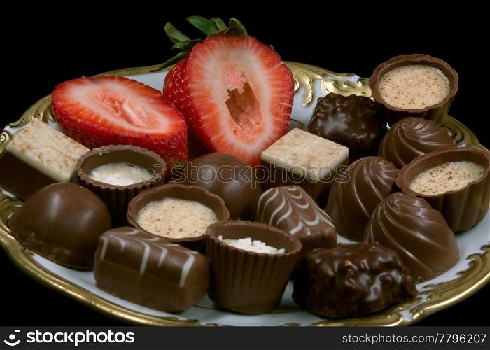 pralines decorated with a strawberry on a plate