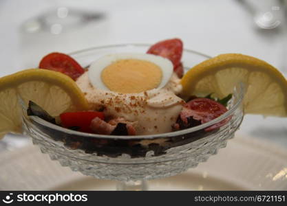 prawn cocktail decorated with lemon and tomato