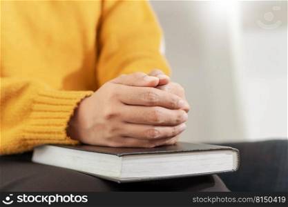 Pray and religion concept, Female christian hands folded on holy bible and praying to god.